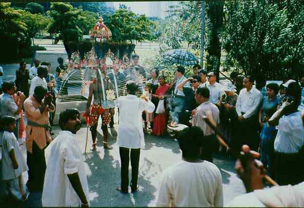 Family and friends cheer on as a devotee approaches the Thandayudhapani Temple, Tank Road