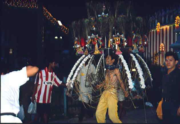 A Chinese devotee with his elaborate kavadi is not a rare sight during Thaipusam in Singapore